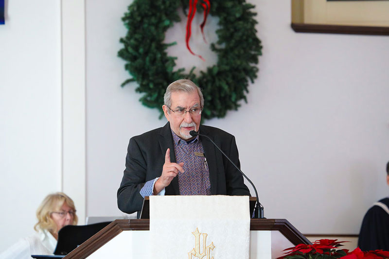 man standing at a pulpit giving a sermon